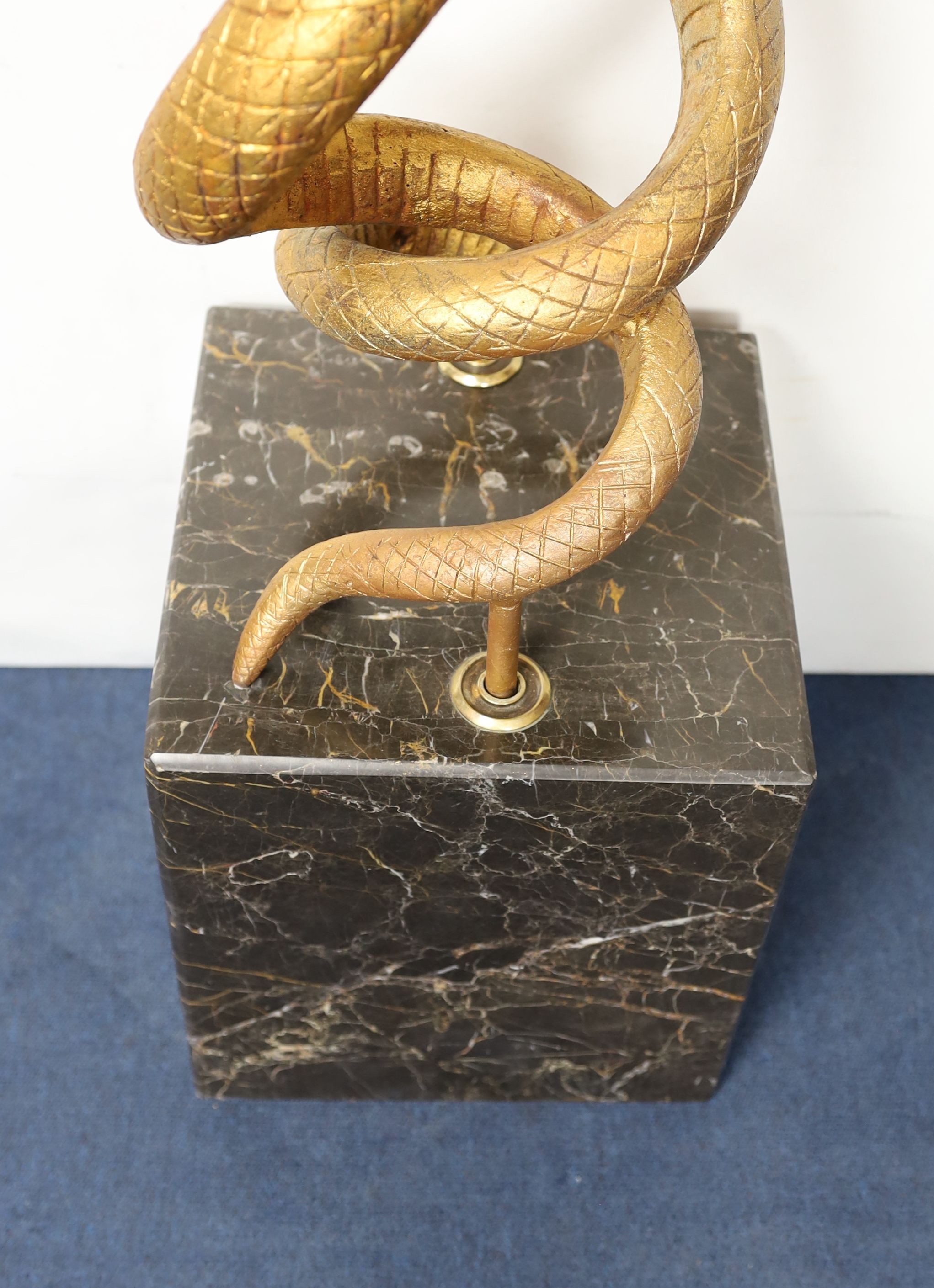 After Edgar Brandt. A gilt cast iron group of two entwined snakes, width 66cm height 121cm